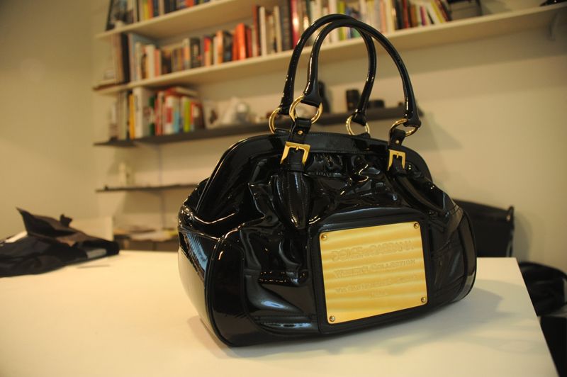 Dolce Gabbana Black Patent leather hand bag with gold badge/accents 